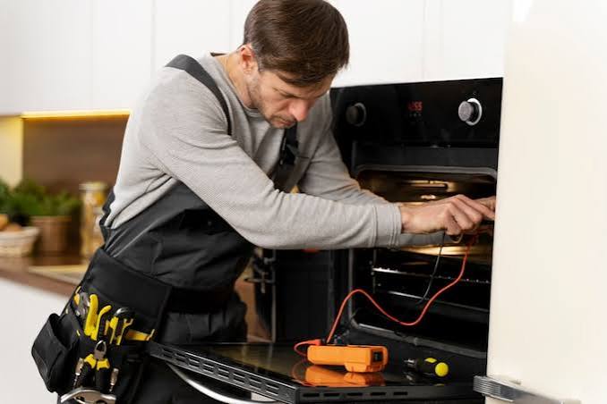 Technician performing precise appliance repair